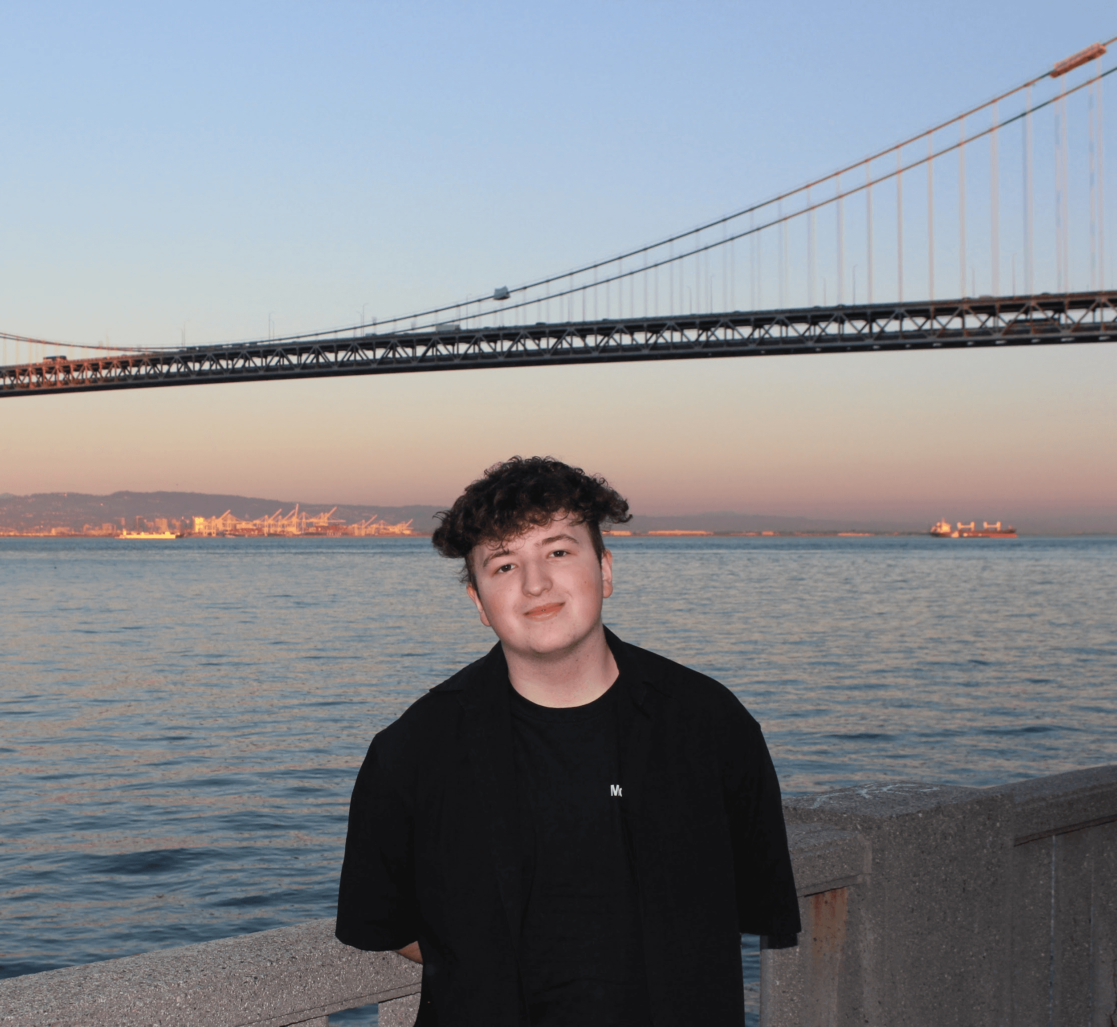 A photo of Ruslan Mukhamedvaleev in San Francisco in front of the bay bridge, at Mozilla's Demo Day event for Koel Labs
